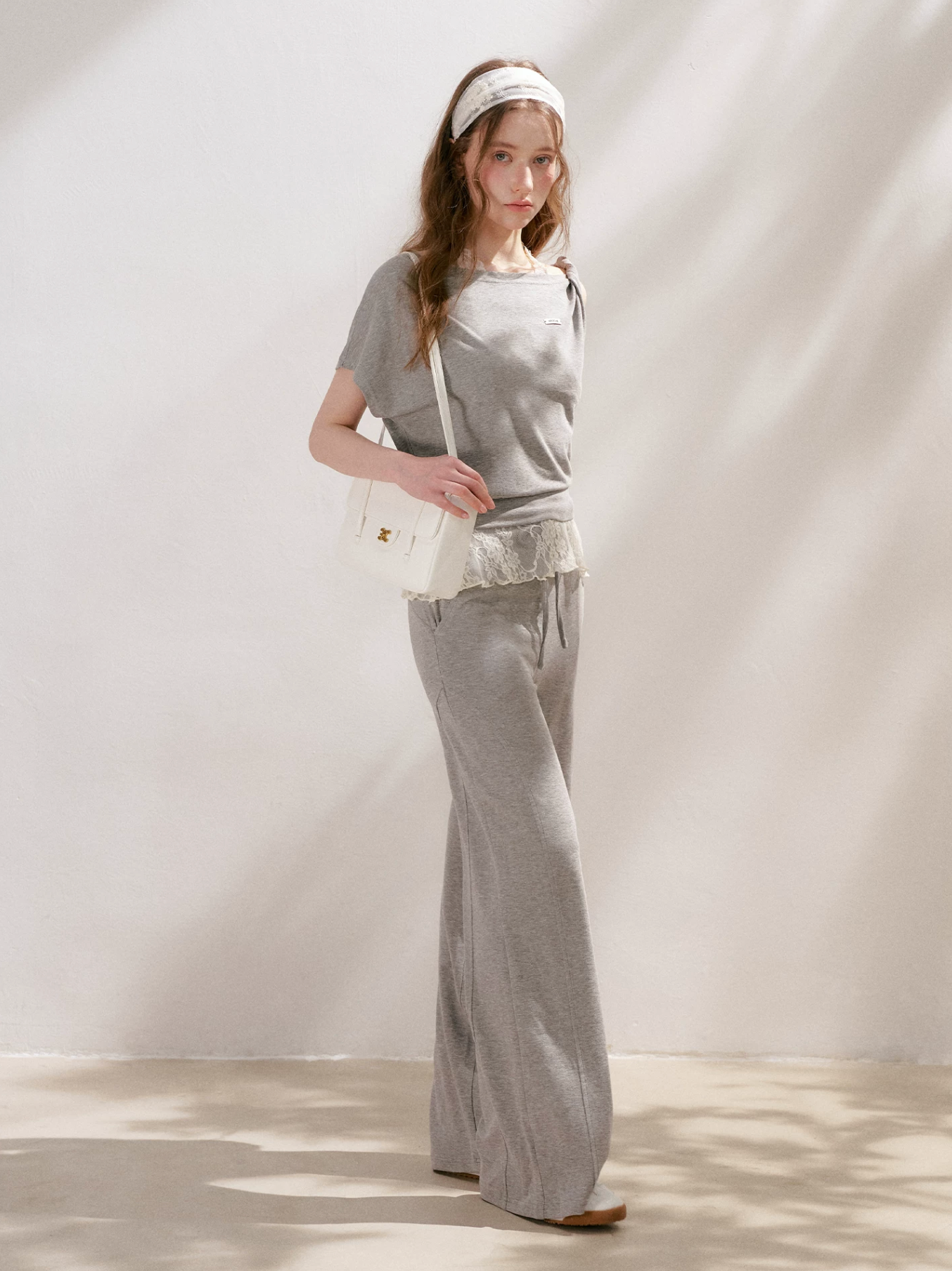 KROCHE Romantic French outfit includes a buttoned off-the-shoulder t-shirt and a halterneck lace tank top and wide-leg pants.