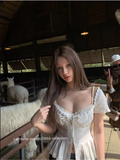 LATTITUDE White short-sleeved shirt with feminine hollow out lace trim.