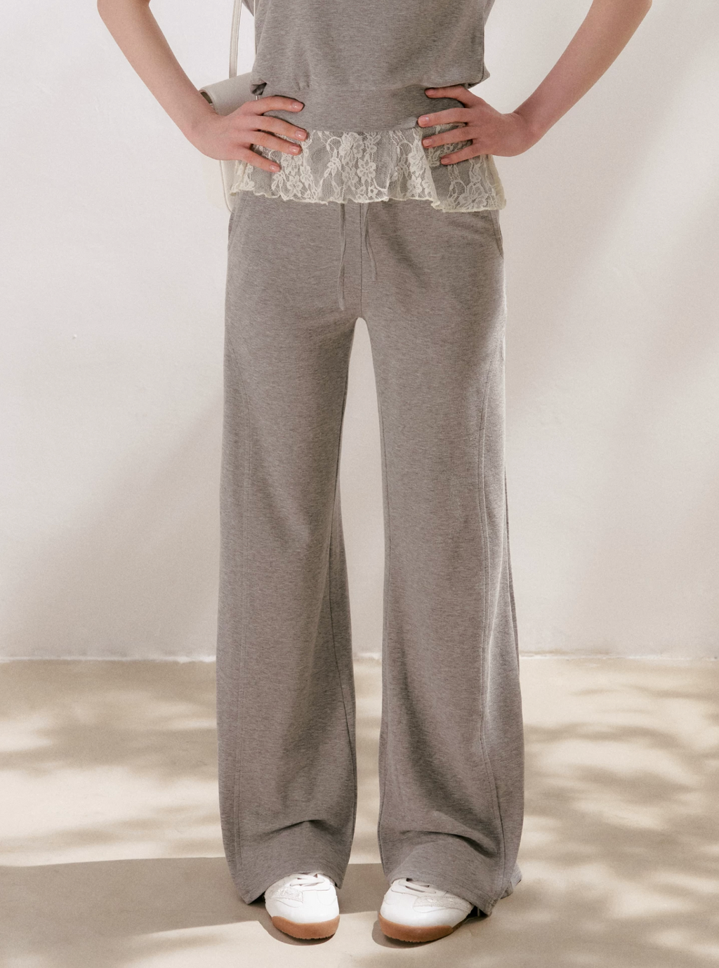 KROCHE Romantic French outfit includes a buttoned off-the-shoulder t-shirt and a halterneck lace tank top and wide-leg pants.