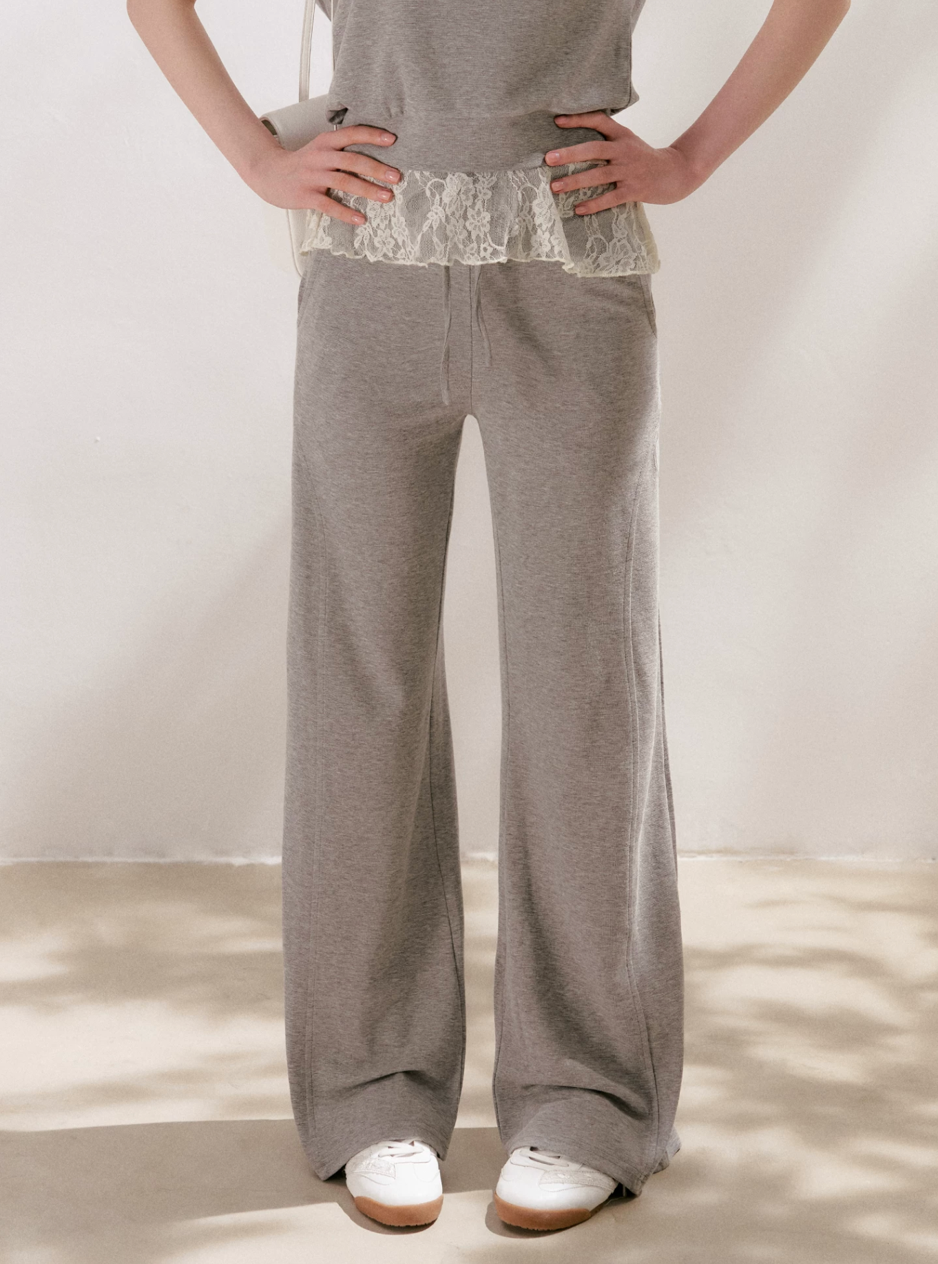 KROCHE Romantic French outfit includes a buttoned off-the-shoulder t-shirt and a halterneck lace tank top and wide-leg pants.