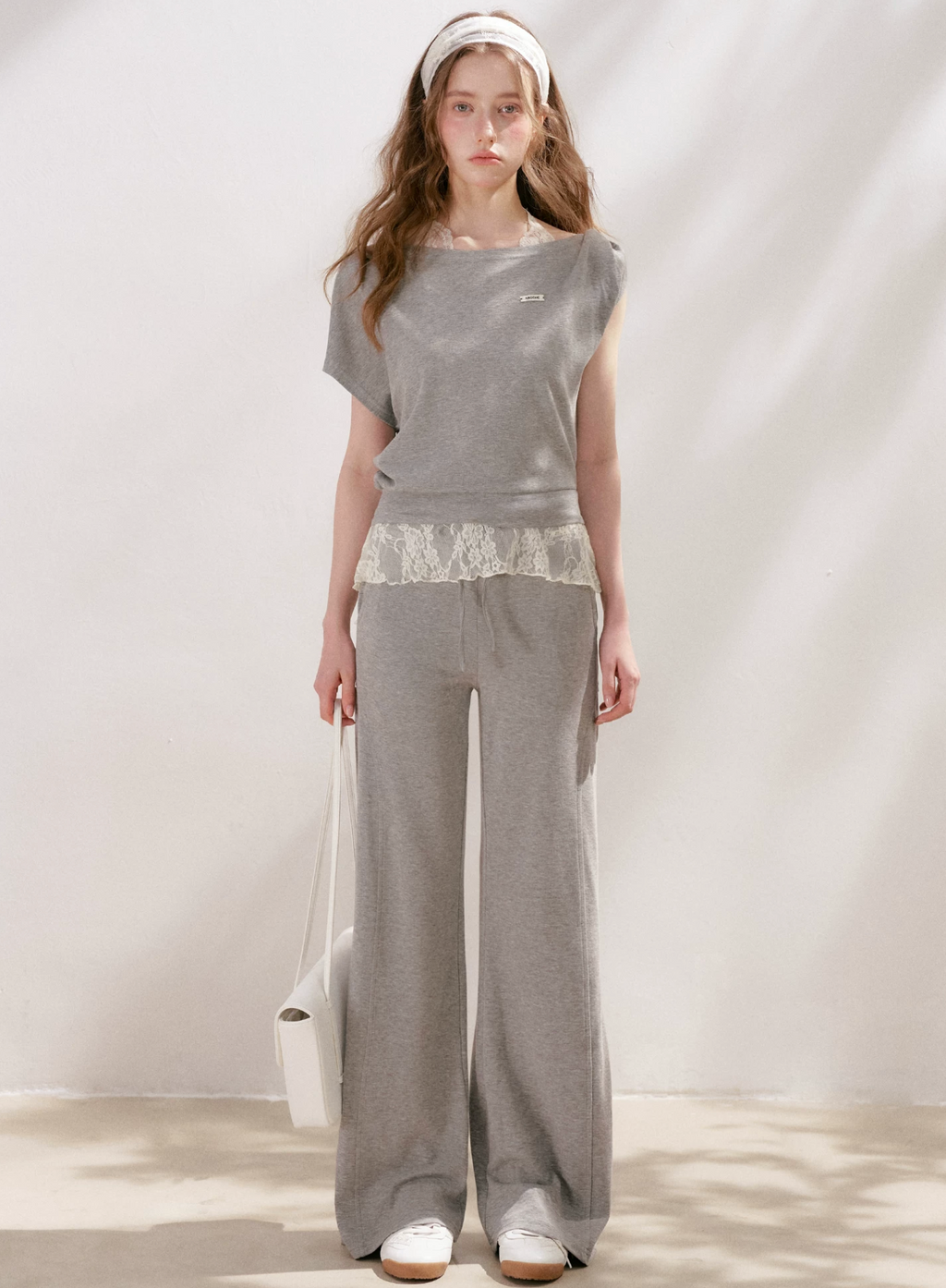 KROCHE Romantic French outfit includes a buttoned off-the-shoulder t-shirt and a halterneck lace tank top and wide-leg pants.