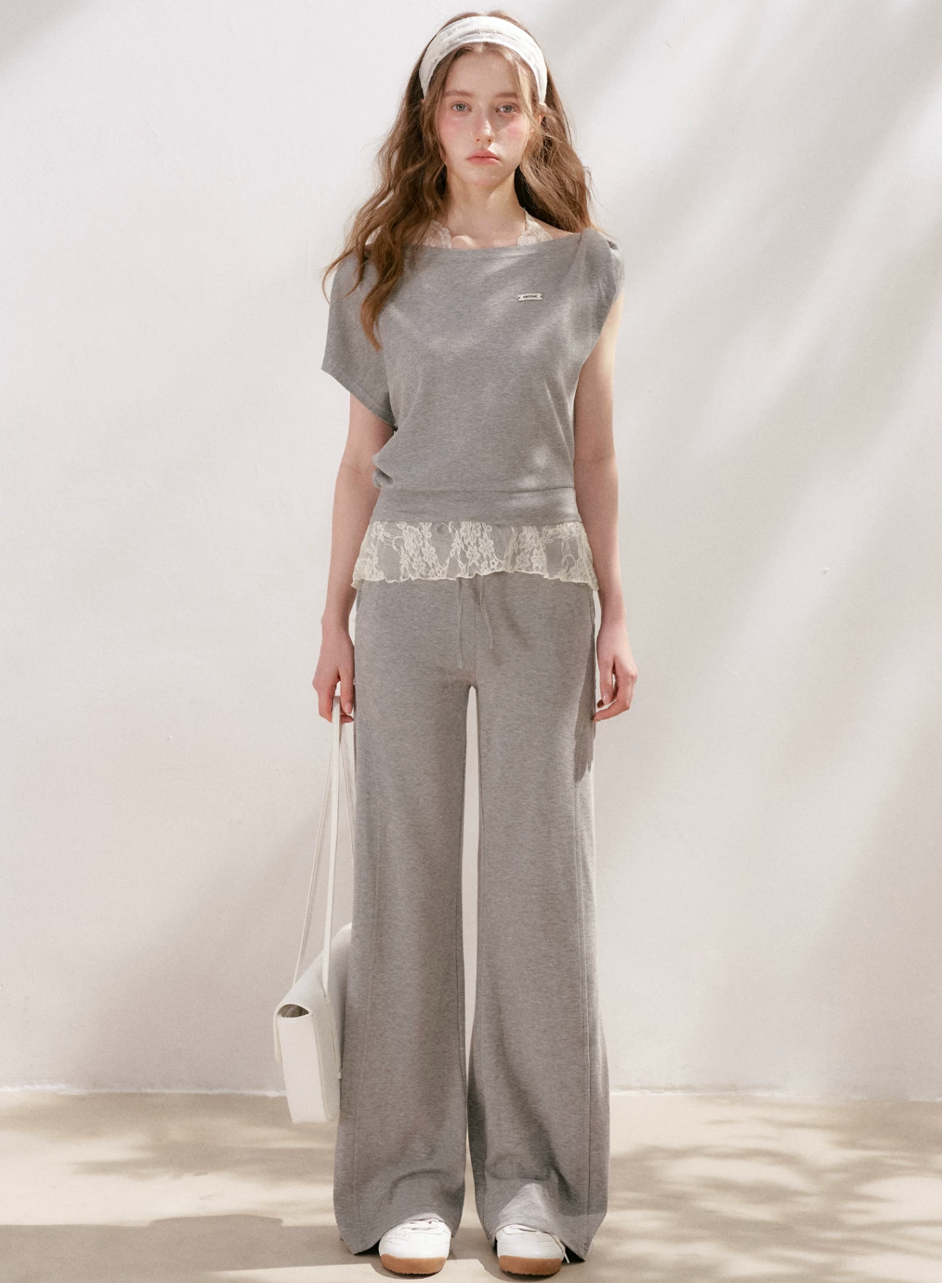 KROCHE Romantic French outfit includes a buttoned off-the-shoulder t-shirt and a halterneck lace tank top and wide-leg pants.