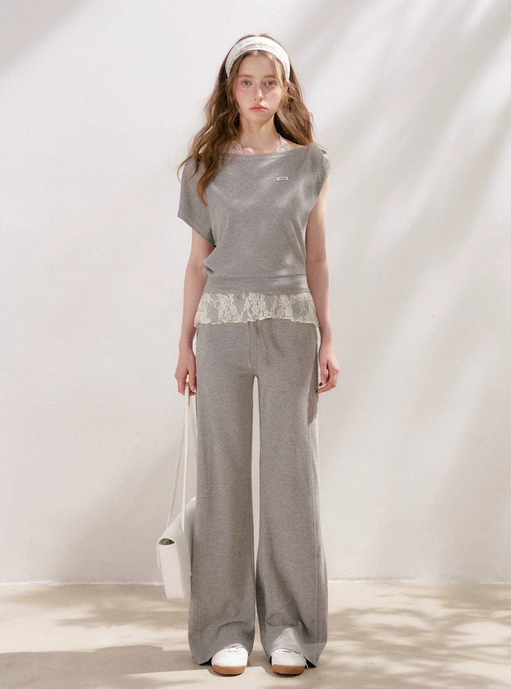KROCHE Romantic French outfit includes a buttoned off-the-shoulder t-shirt and a halterneck lace tank top and wide-leg pants.