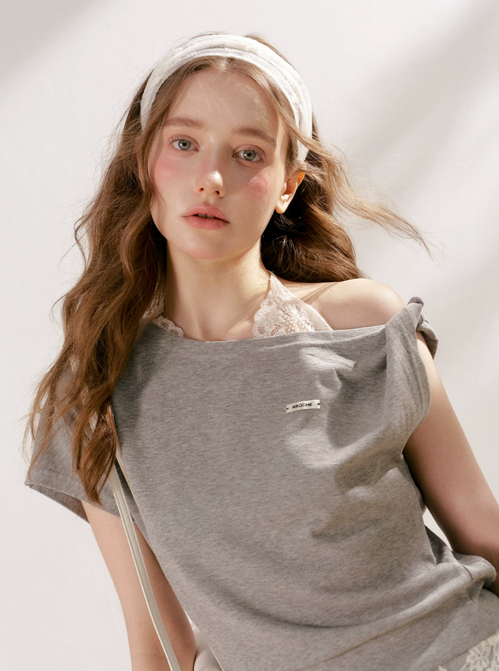 KROCHE Romantic French outfit includes a buttoned off-the-shoulder t-shirt and a halterneck lace tank top and wide-leg pants.