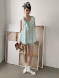 MineBeThyVers Loose-fitting ruffled layered lace mint green suit and pumpkin shorts.